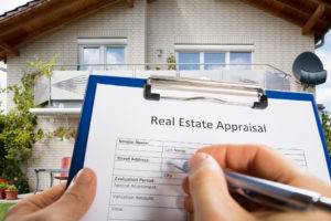 inspector appraiser filling out appraisal form on clipboard Turner Appraisals Company Denver